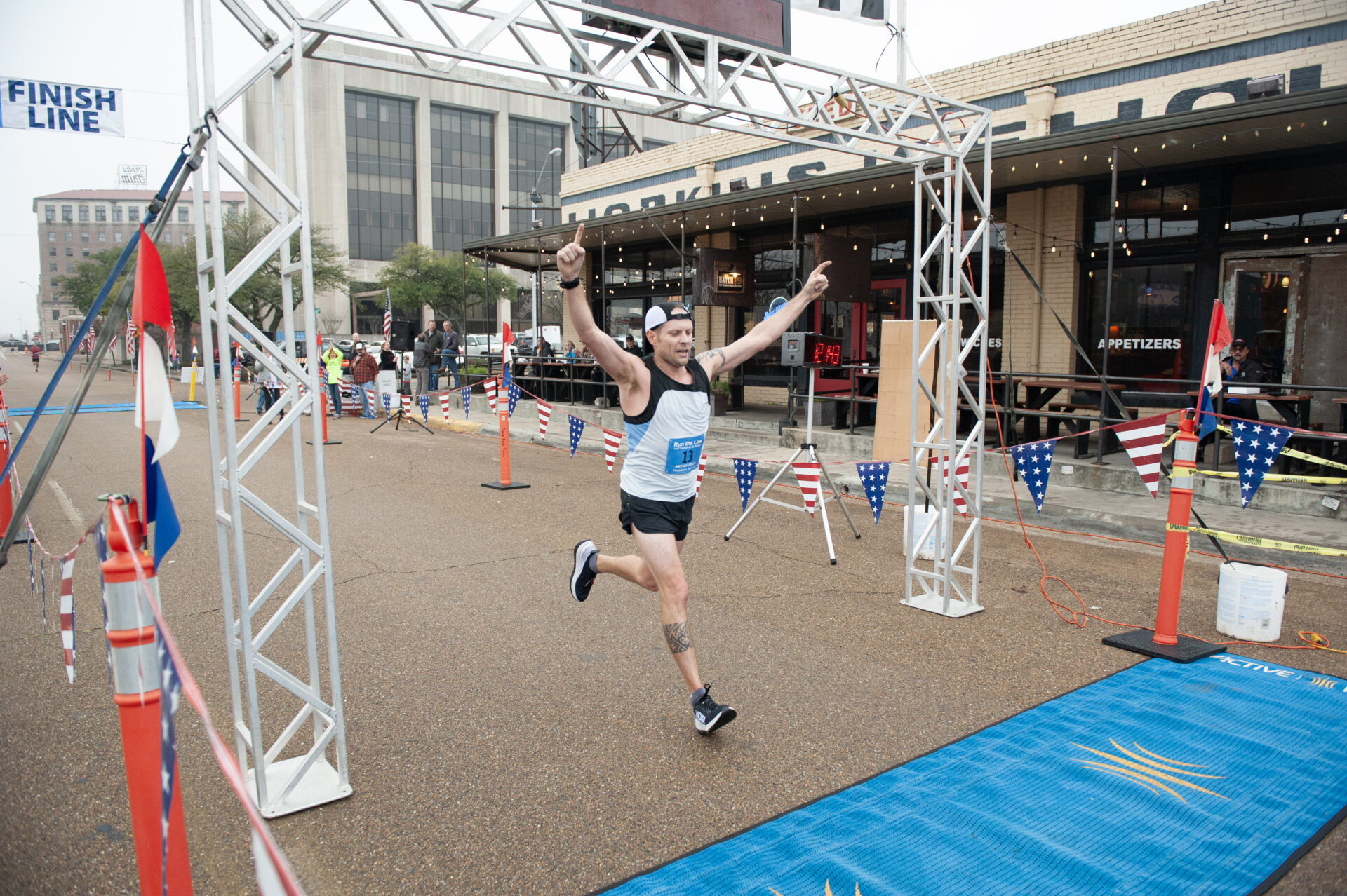 Runner celebrates while crossing the Run the Line finish line.