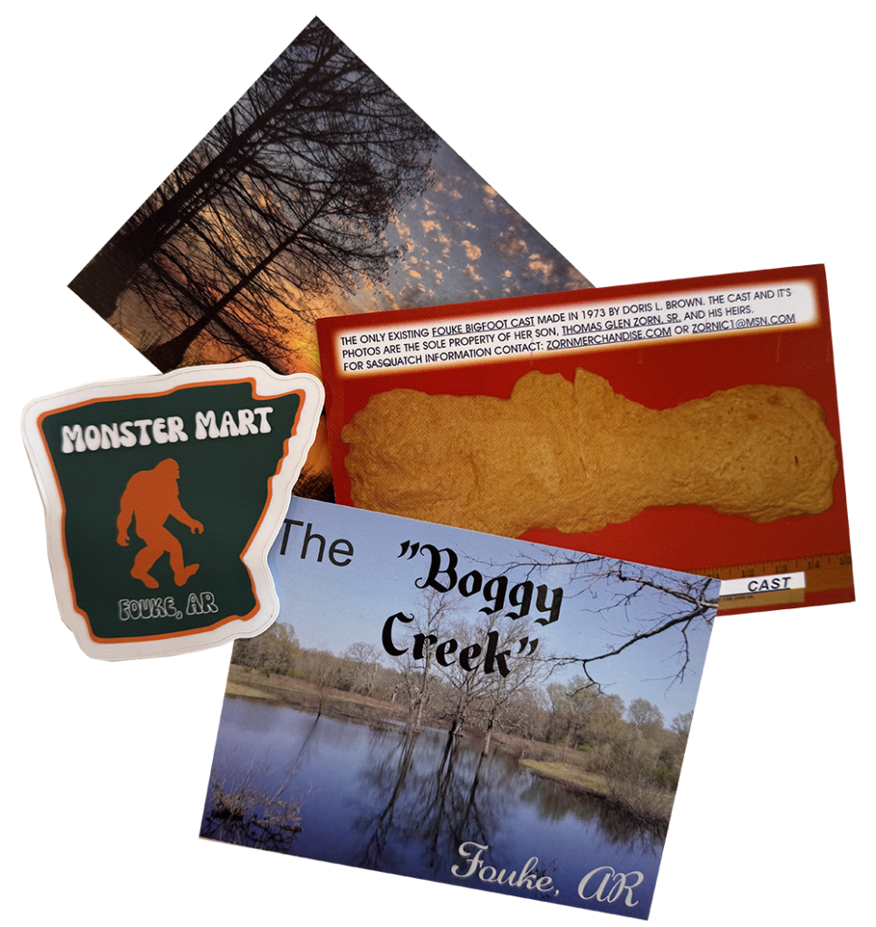Postcards and a sticker featuring Boggy Creek and the Monster Mart