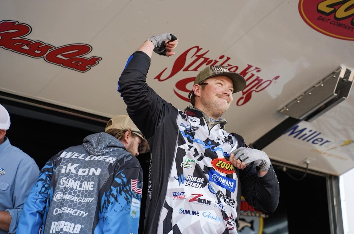 NPFL angler celebrating on stage during fishing tournament weigh-in near Texarkana.
