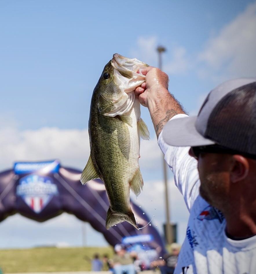 Angler holding bass during NPFL fishing tournament weigh-in near Texarkana 