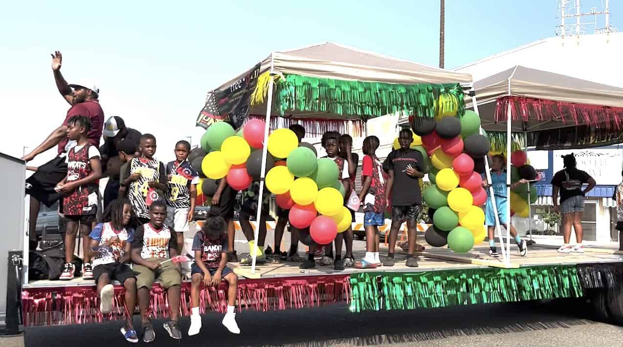 Children ride a decorated float during the Texarkana Juneteenth Parade.